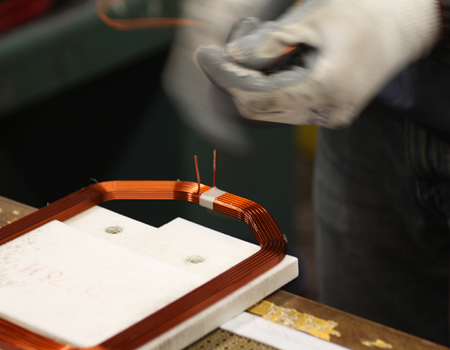 Layered wound thermally bonded freestanding coil.